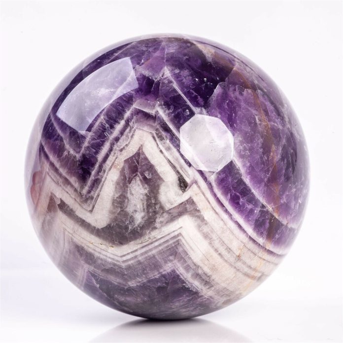 a purple and white ball Banded Amethyst Healing Crystal - Metaphysical Properties and Benefits Mycrysatlpedia.me